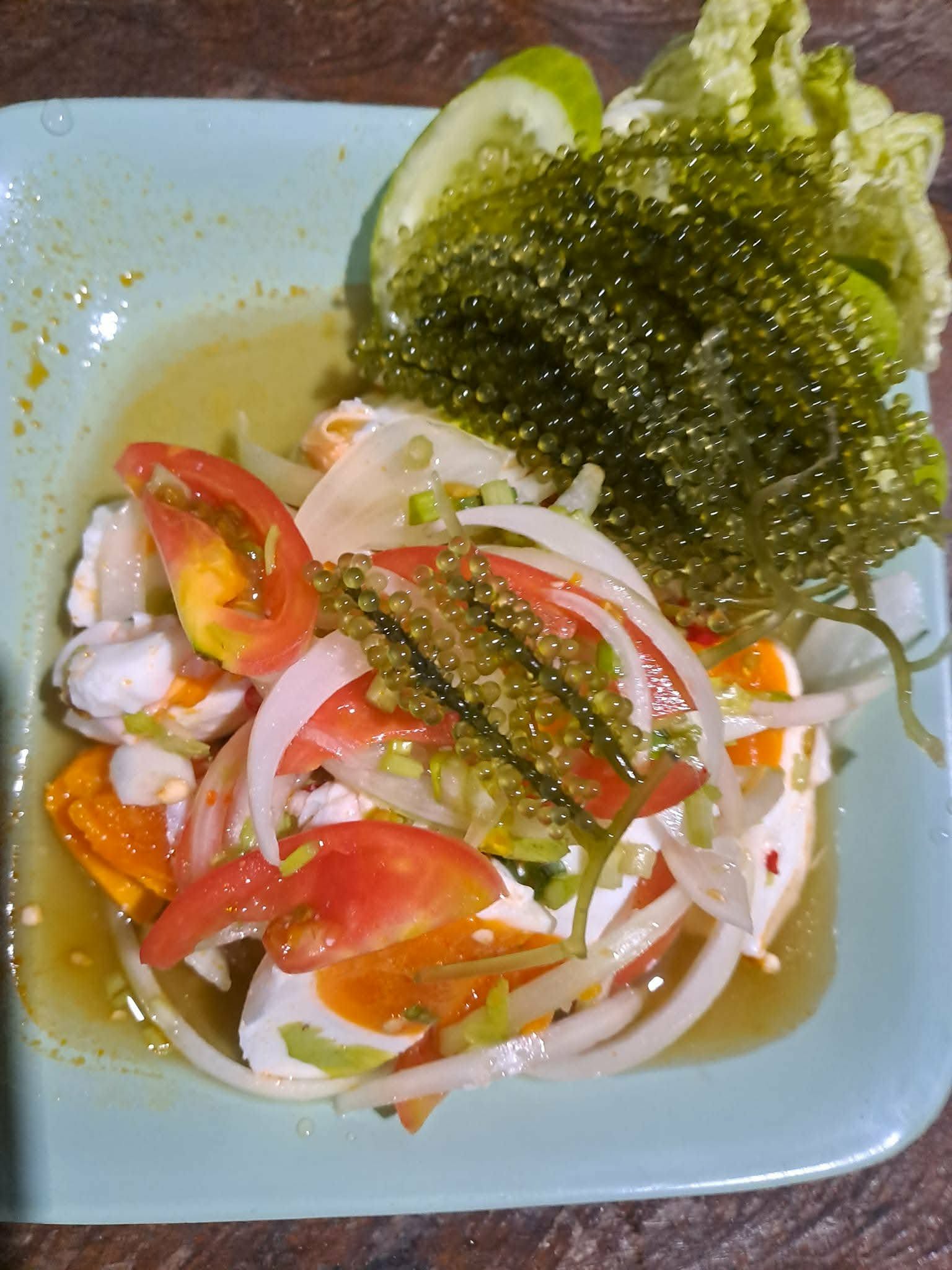 Thai seafood salad with sea grapes, tomato and lime