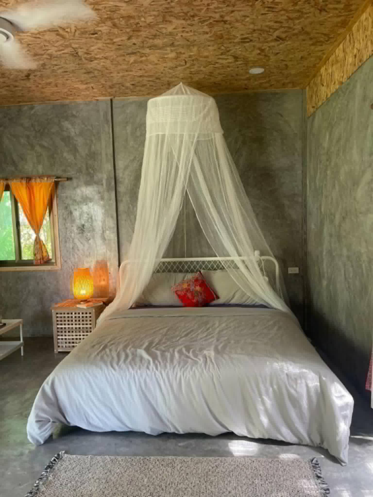 Honeymoon Suite with a canopy bed draped in mosquito netting