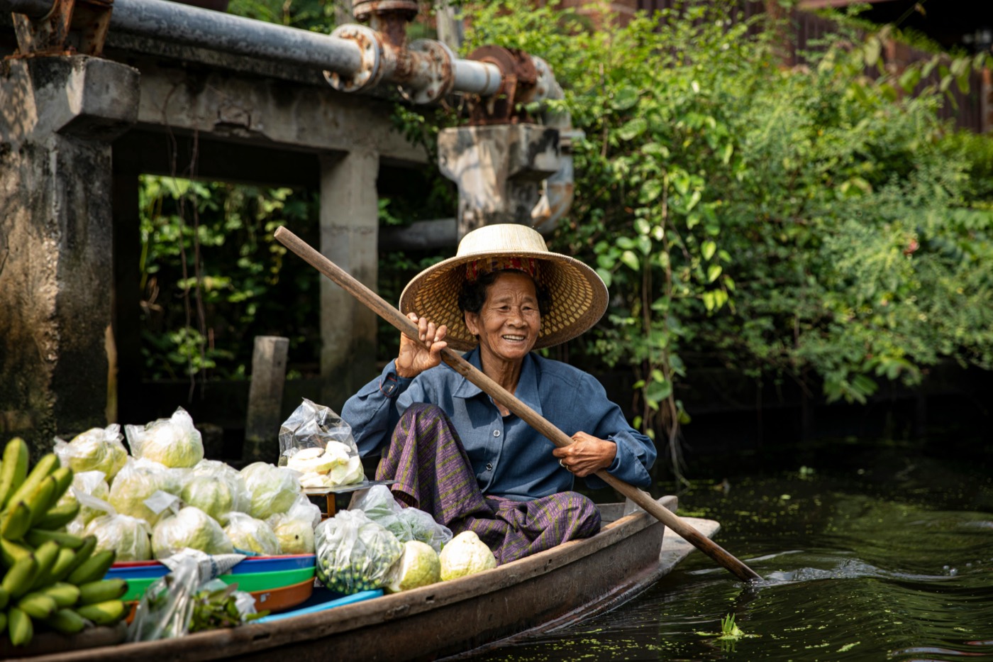 Local vendor on a long-tail boat, one of the guided boat tours available